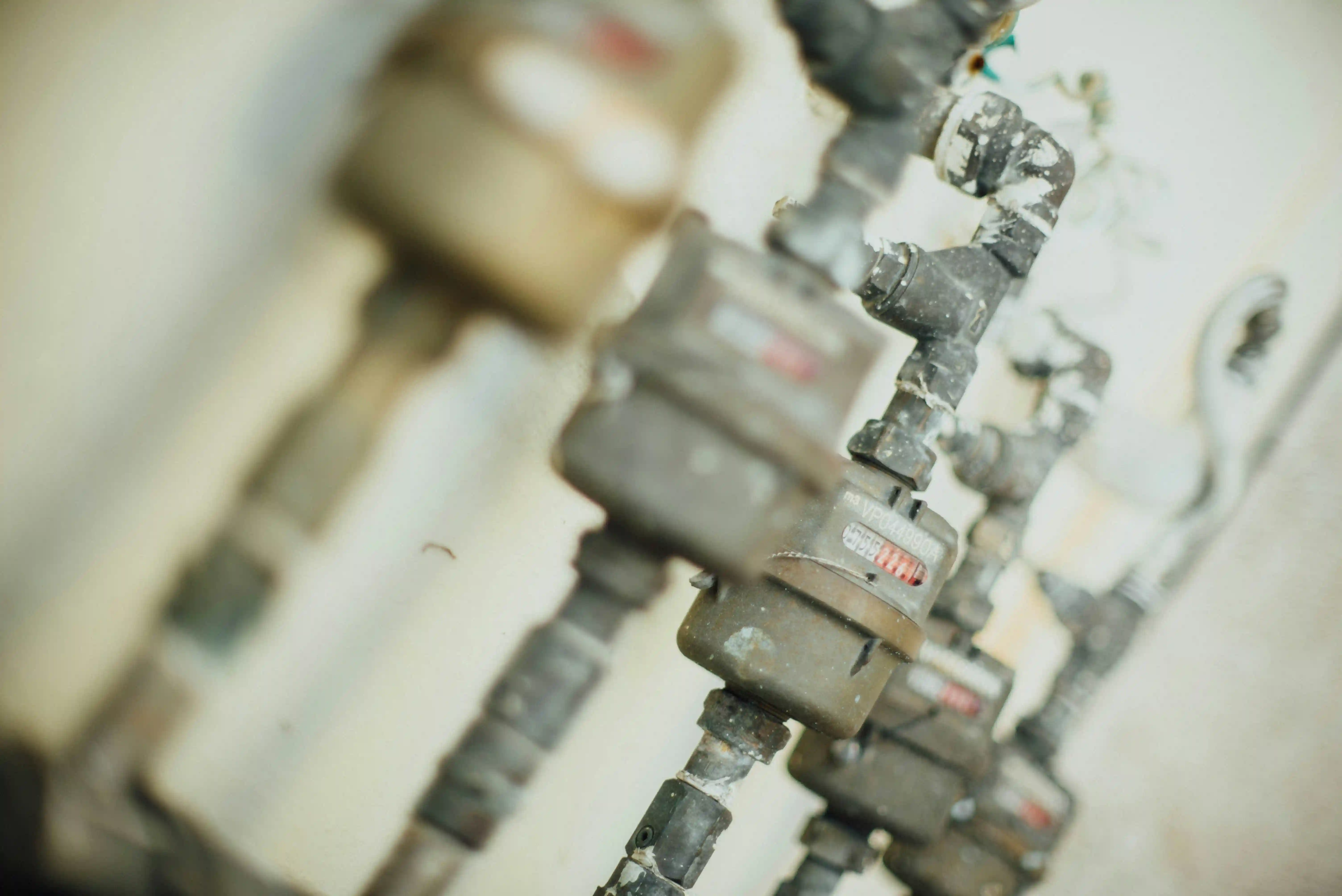 Hands installing a new kitchen mixer tap